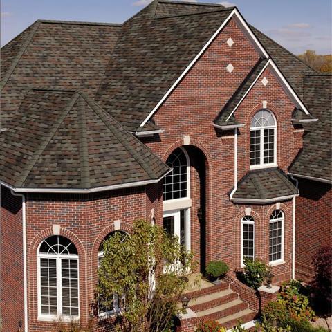 Large brick home with a new roof replacement courtesy of Middle Creek Roofing