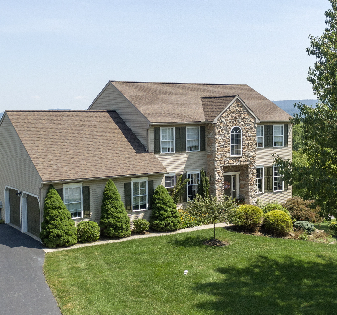 Curbside view of home after receiving emergency roof repair services