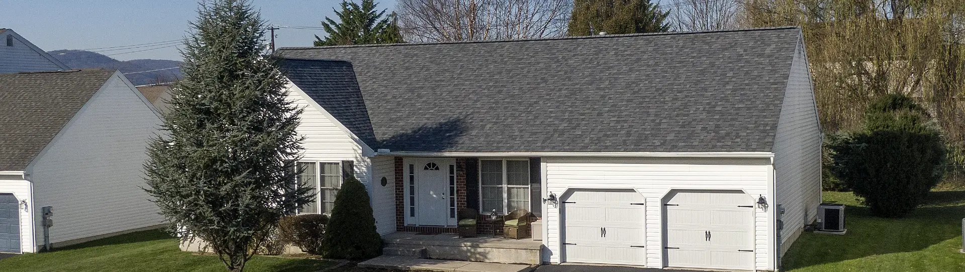 Close up, curbside view of a small home in Southeastern PA with new shingles courtesy of Middle Creek Roofing