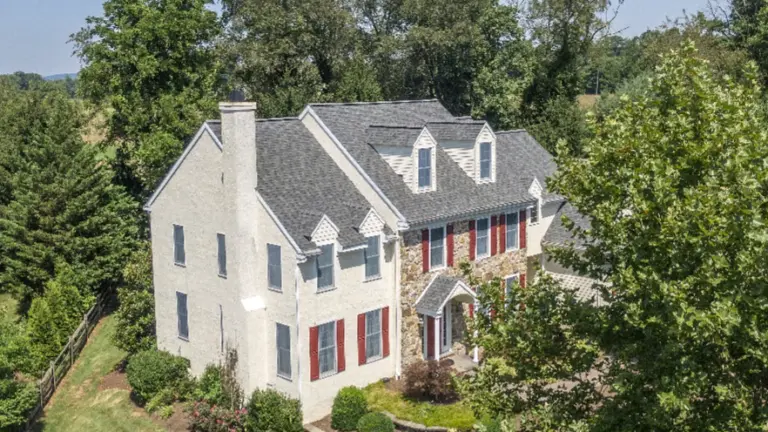 Shingle Roof on cream colored house in Pennsylvania courtesy of Middle Creek Roofing