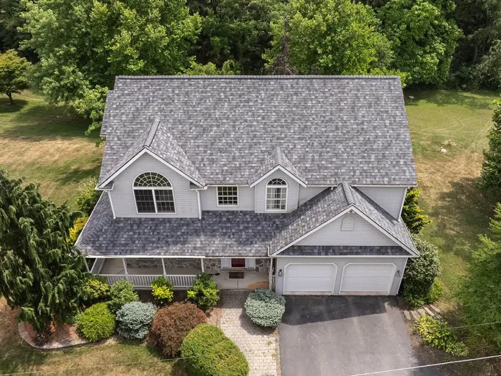 white house with grey shingle roofing