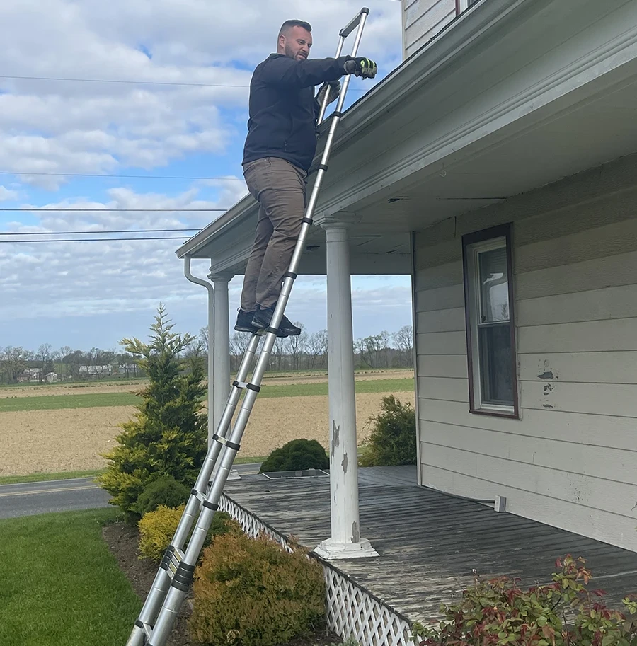 middle creek roofer on a ladder